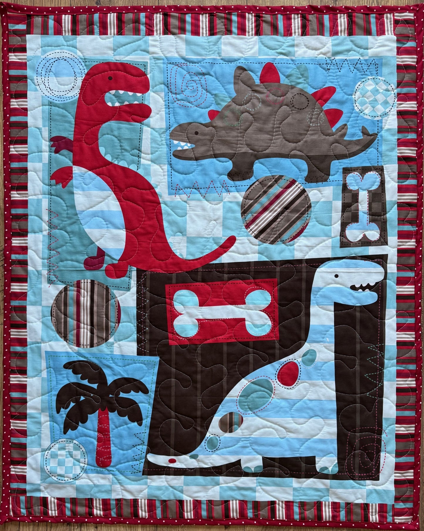 Variety of Dinosaurs Red, Brown, Blue Quilted Blanket